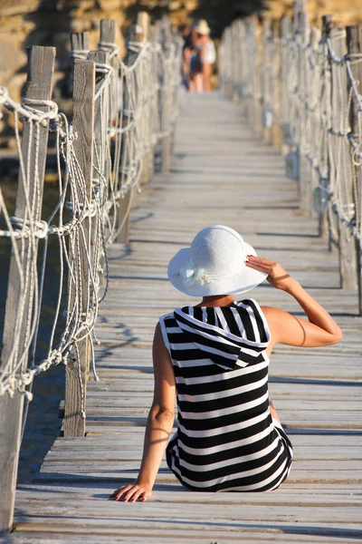 Σέξι γυναίκα στη γέφυρα πάνω από την θάλασσα — Φωτογραφία Αρχείου