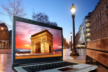 Paris Champs Elysee street in the evening and laptop clipart