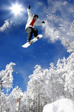 Mavi gökyüzüne atlayan snowboardcu