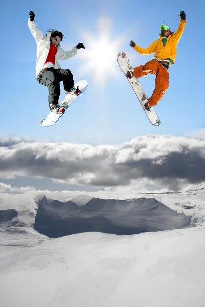 Snowboarders jumping against blue sky — Stock Photo, Image