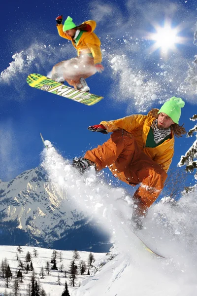 stock image Snowboarders jumping against blue sky