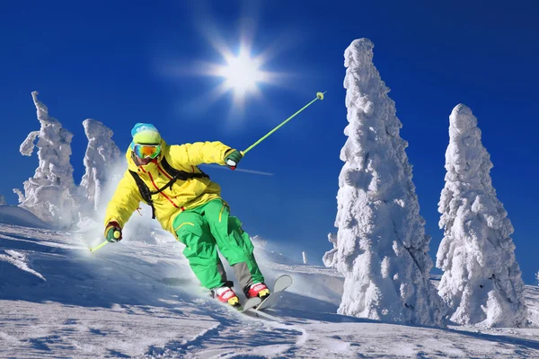 Skier skiing downhill in high mountains — Stock Photo, Image