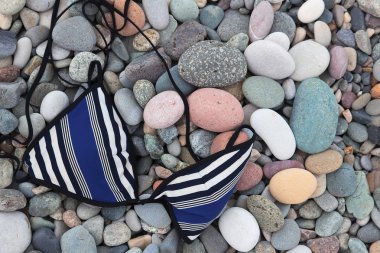 Swimsuit top on pebbles. Batumi. Georgia. clipart