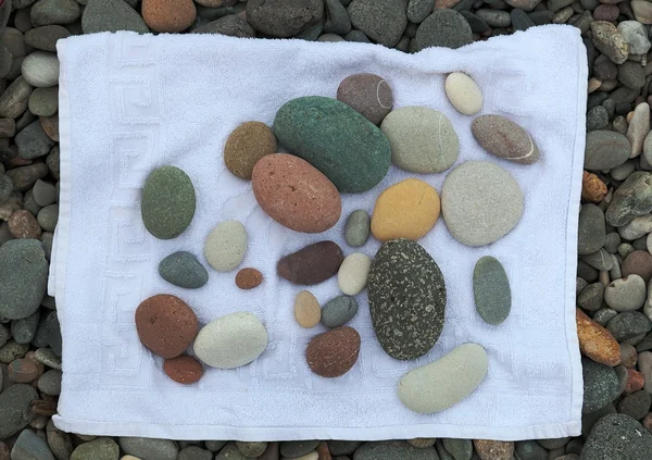 Pebbles on a towel. Batumi. Georgia. — Stock Photo, Image