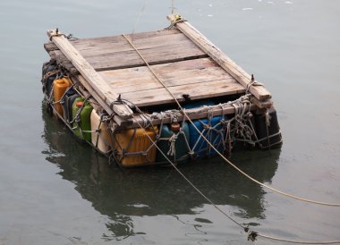 Personal pontoon ferry made from empty plastic containers. Cheung Chau. Hong Kong. clipart