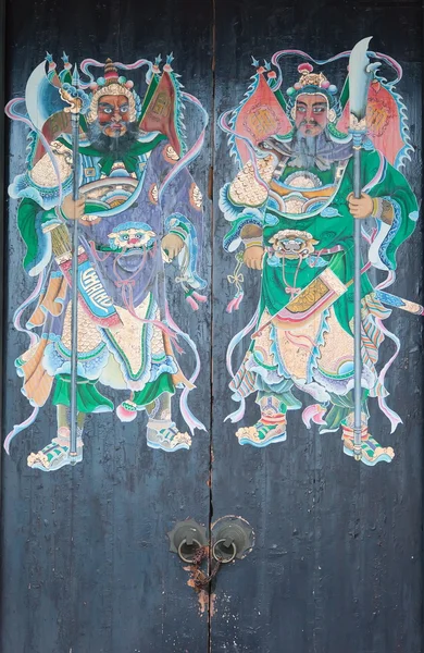 Two warriors (door gods) on the gate of Yeung Hay Temple. Hong Kong.