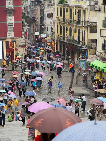 Under colourful umbrellas. Rainy day. Macau. China. — Stock Photo, Image