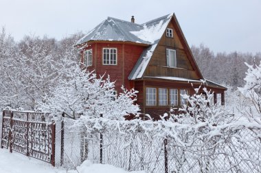 House in countryside (dacha) after heavy snowfall. Moscow region. Russia. clipart