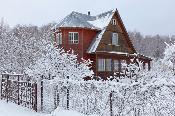 House in countryside (dacha) after heavy snowfall. Moscow region. Russia.