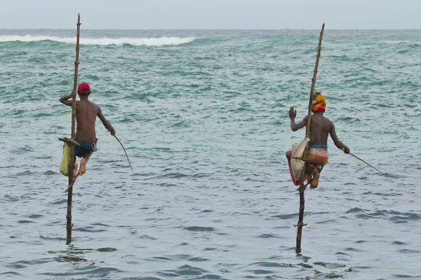 stock image 2 fishermen on sticks