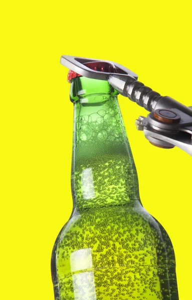 Opening beer bottle with metal opener — Stock Photo, Image