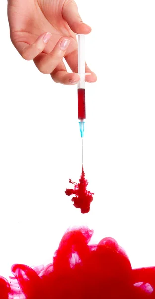 Hand holding medical syringes with blood in water — Stock Photo, Image