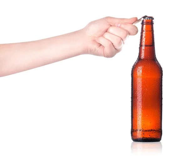 Hand opening beer bottle with metal opener — Stock Photo, Image