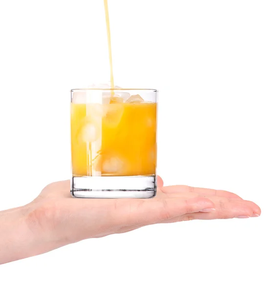 Fresh orange juice pouring in to the glass with hand isolated — Stock Photo, Image