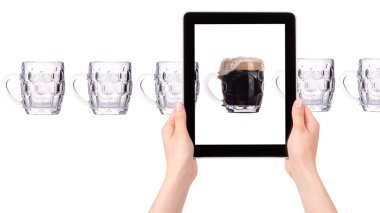 Empty and one full beer on tablet computer screen clipart