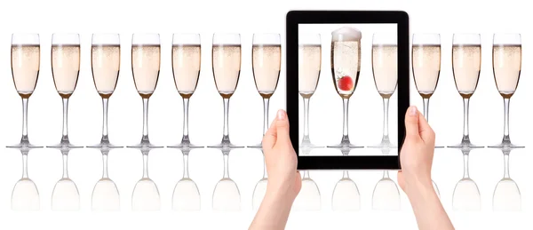 Glass of champagne on tablet computer screen — Stock Photo, Image