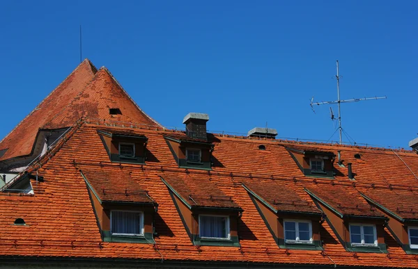 stock image Red mansard roof with windows