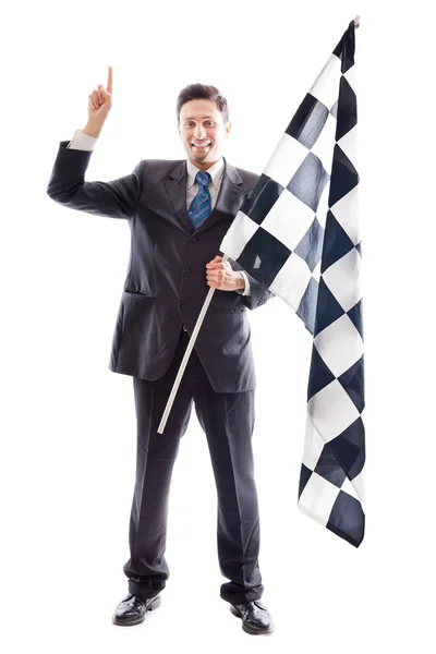 Молодой бизнесмен и клетчатый флаг — стоковое фото