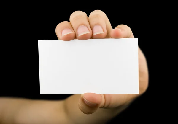 stock image Blank business card in a hand isolated on black