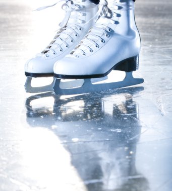 Dramatic blue portrait shot of ice skates clipart