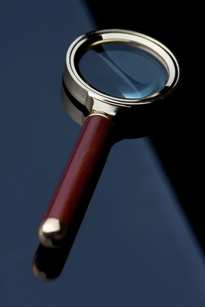 stock image Magnifying glass on black table