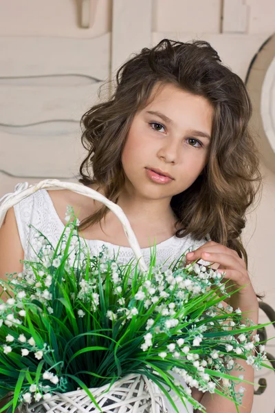 Girl with lily of the valley — Stock Photo, Image