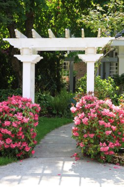 Garden arbor and pink flowers. clipart