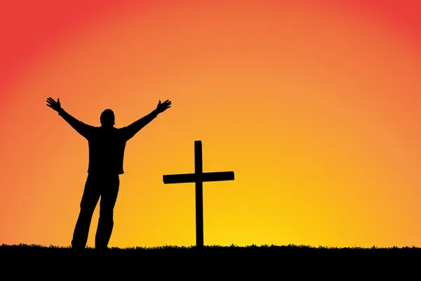 Силуэт человека и крест на закате — стоковое фото