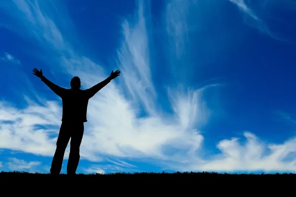 Silhouette of man with arms outstretched to the sky — Stock Photo, Image