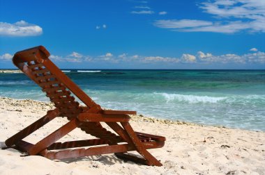 Lounge chairs on a tropical beach clipart