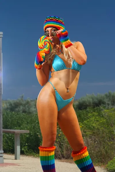 Sexy bikini girl with colorful lollipop — Stock Photo, Image