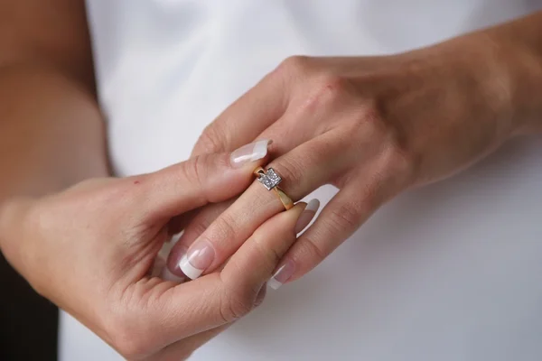 Bride placing on her engagement ring. — Stock Photo, Image
