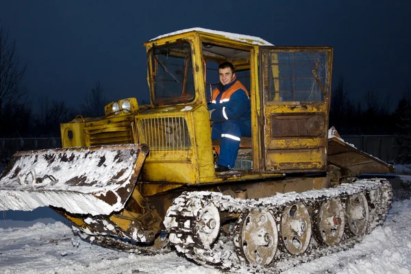 Tractor clearing snow at night — Stock Photo, Image
