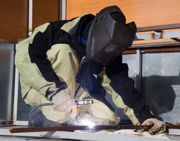 Welder in a special suit while working — Stock Photo, Image