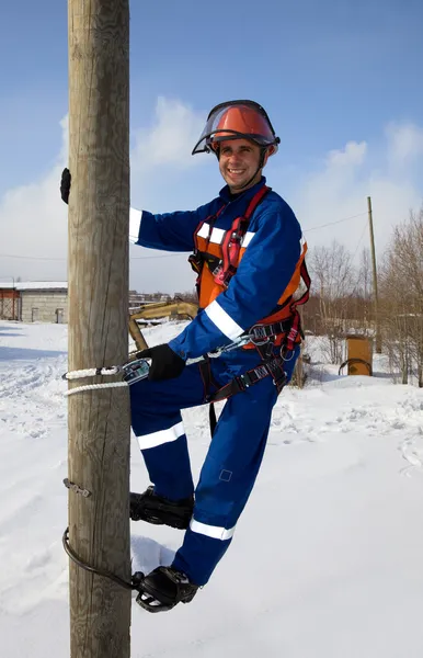 Electrician on a pole in a good mood — Stock Photo, Image