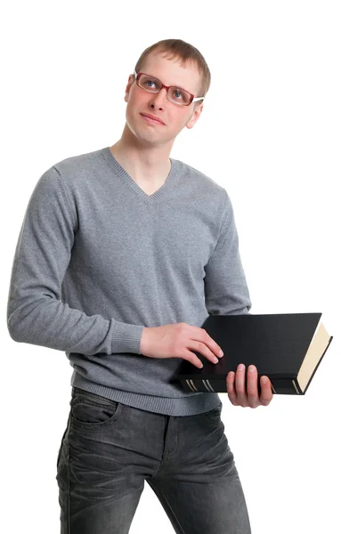 Jeune étudiant en lunettes avec un livre dans les mains — Photo