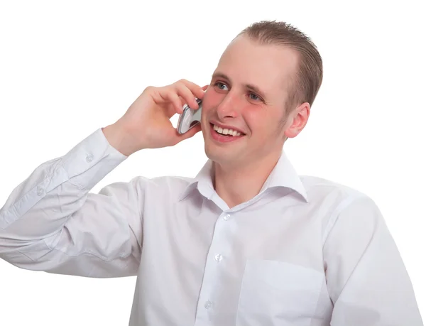 Mladý muž říká s úsměvem na vašem mobilním telefonu — Stock fotografie