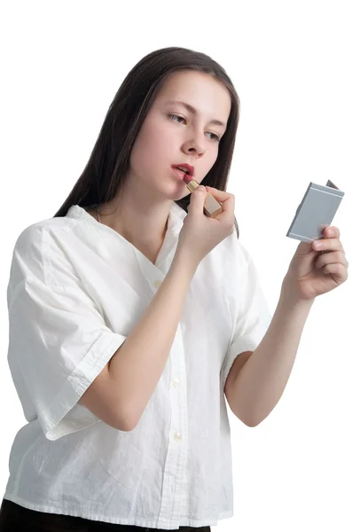 A young girl with her hair applying lipstick — Stock Photo, Image