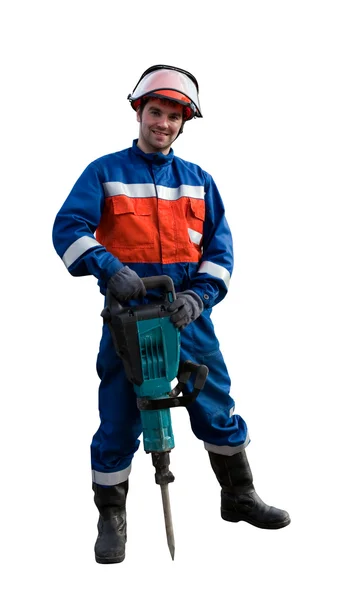 Worker in overalls with an electric hammer — Stock Photo, Image
