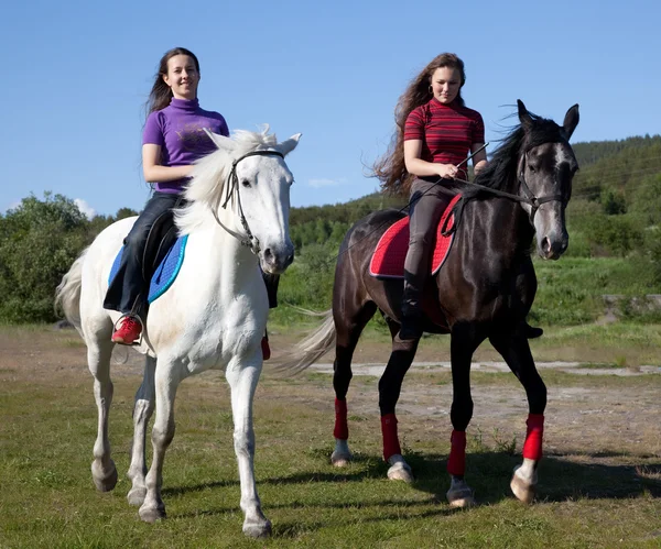 Dwie dziewczyny chodzić na koniu — Zdjęcie stockowe