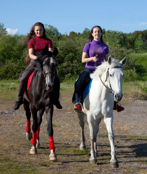 Two girls walking on horseback — Stock Photo, Image