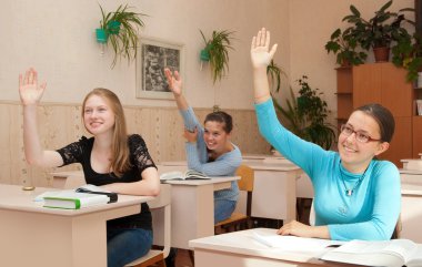 Schoolgirl in class raised their hands clipart