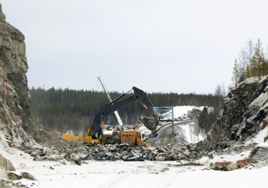 Construction of the road through the rock clipart