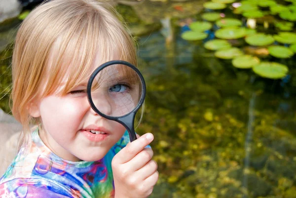 Girl with magnifying glass