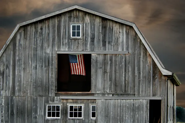 Stary stodoła na zachód słońca z flagą — Zdjęcie stockowe