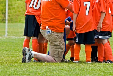 Soccer coach with team clipart