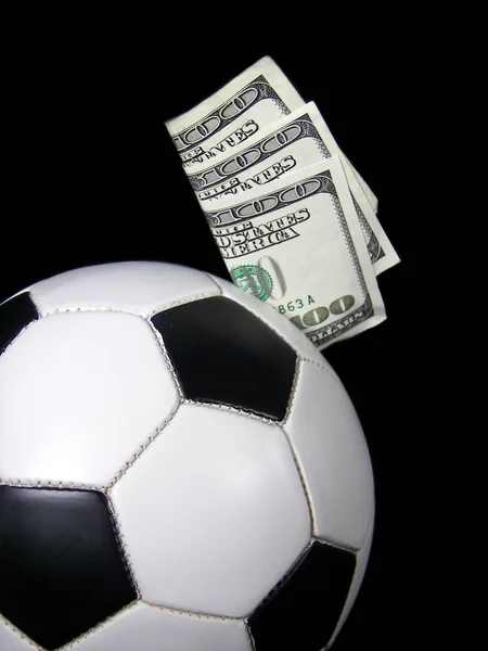 Dinheiro em uma bola de futebol — Fotografia de Stock