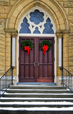 Christmas wreaths on church doors clipart