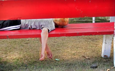 Boy sleeping on bench clipart