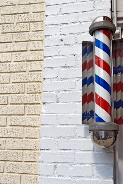 stock image Barber shop pole on brick